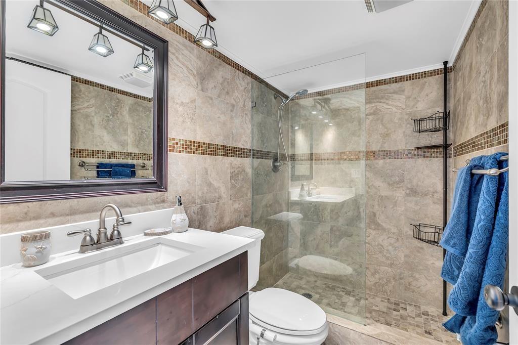 3150 Northeast 48th Court, Unit 204 Lighthouse Point, FL 33064 - Photo 16 of 28 a bathroom with a sink toilet a mirror and shower