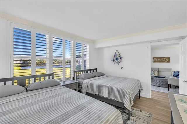 a bedroom with two beds and a large window
