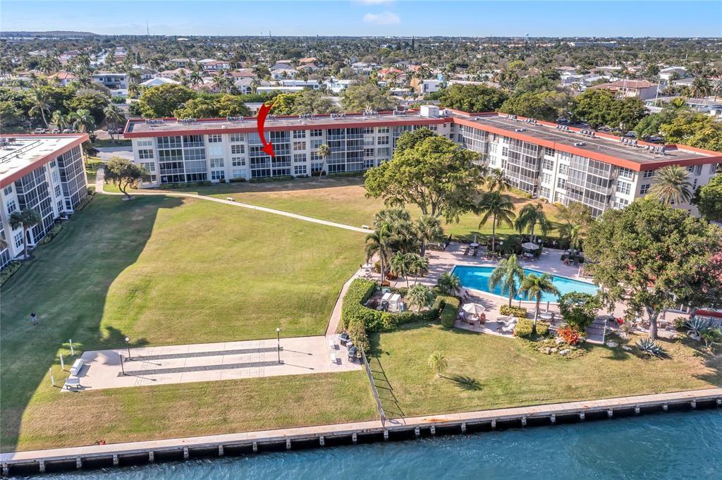 3150 Northeast 48th Court, Unit 204 Lighthouse Point, FL 33064 - Photo 23 of 28 a view of a swimming pool with a lake