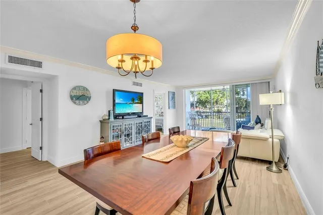 a view of a dining room with furniture and wooden floor