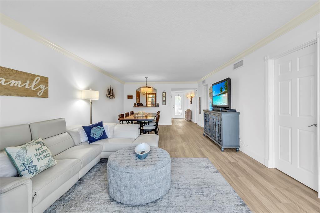 3150 Northeast 48th Court, Unit 204 Lighthouse Point, FL 33064 - Photo 9 of 28 a living room with furniture and a wooden floor
