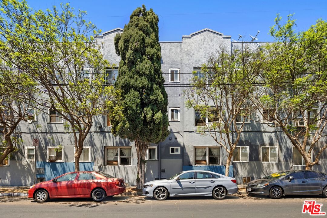 1000 North Serrano Avenue Los Angeles, CA 90029 - Photo 5 of 7 a car parked in front of a building