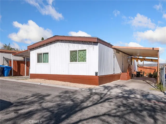 a backyard of a house with barbeque oven table and chairs
