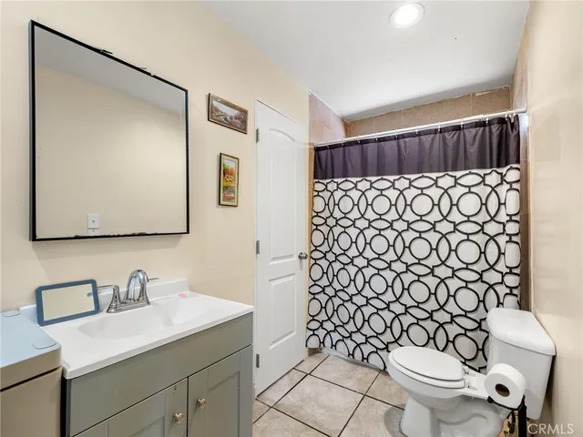 a bathroom with a sink toilet and mirror