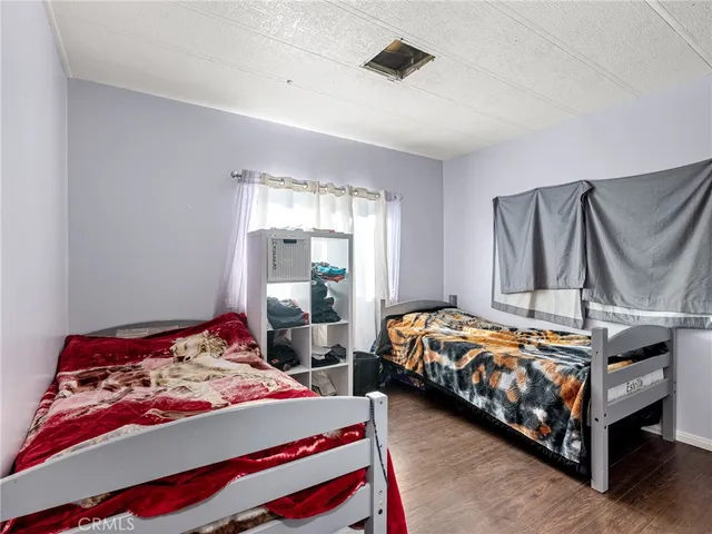 a bedroom with two beds and painted walls