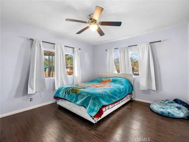 a bed sitting in a bedroom next to a window