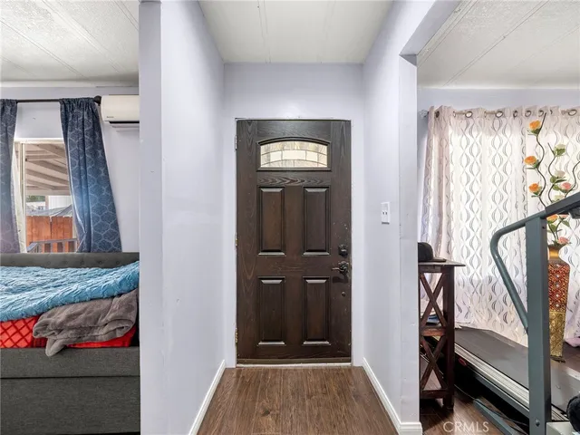 a view of an entryway with wooden floor