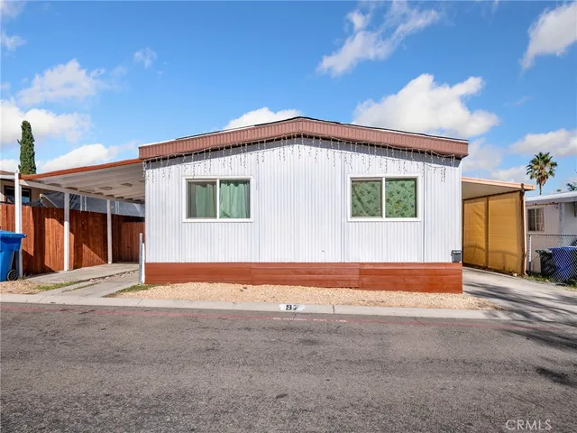 a view of an house with backyard space and balcony