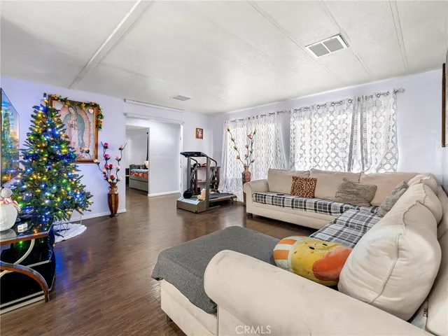 a living room with furniture flowers and a large window