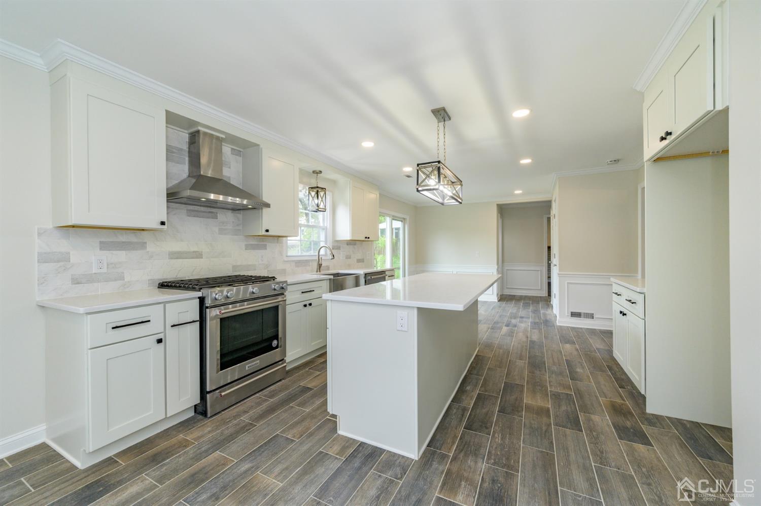 14 Shetland Road Florham Park, NJ 07932 - Photo 12 of 40 a large kitchen with stainless steel appliances granite countertop a lot of counter space and wooden floor