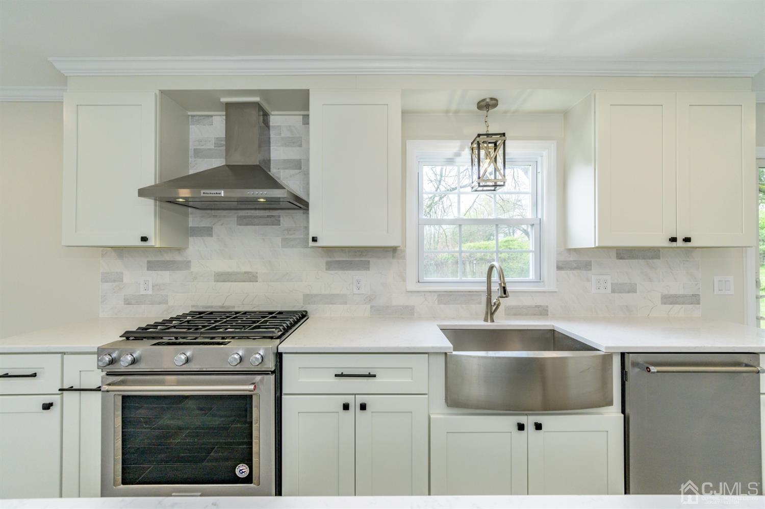 14 Shetland Road Florham Park, NJ 07932 - Photo 13 of 40 a kitchen with stainless steel appliances a stove a sink and a microwave