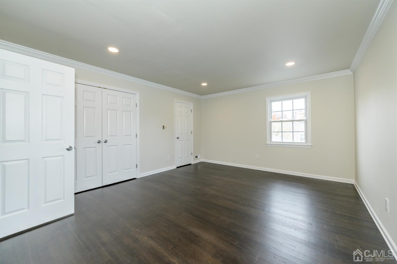 14 Shetland Road Florham Park, NJ 07932 - Photo 20 of 40 an empty room with wooden floor and windows