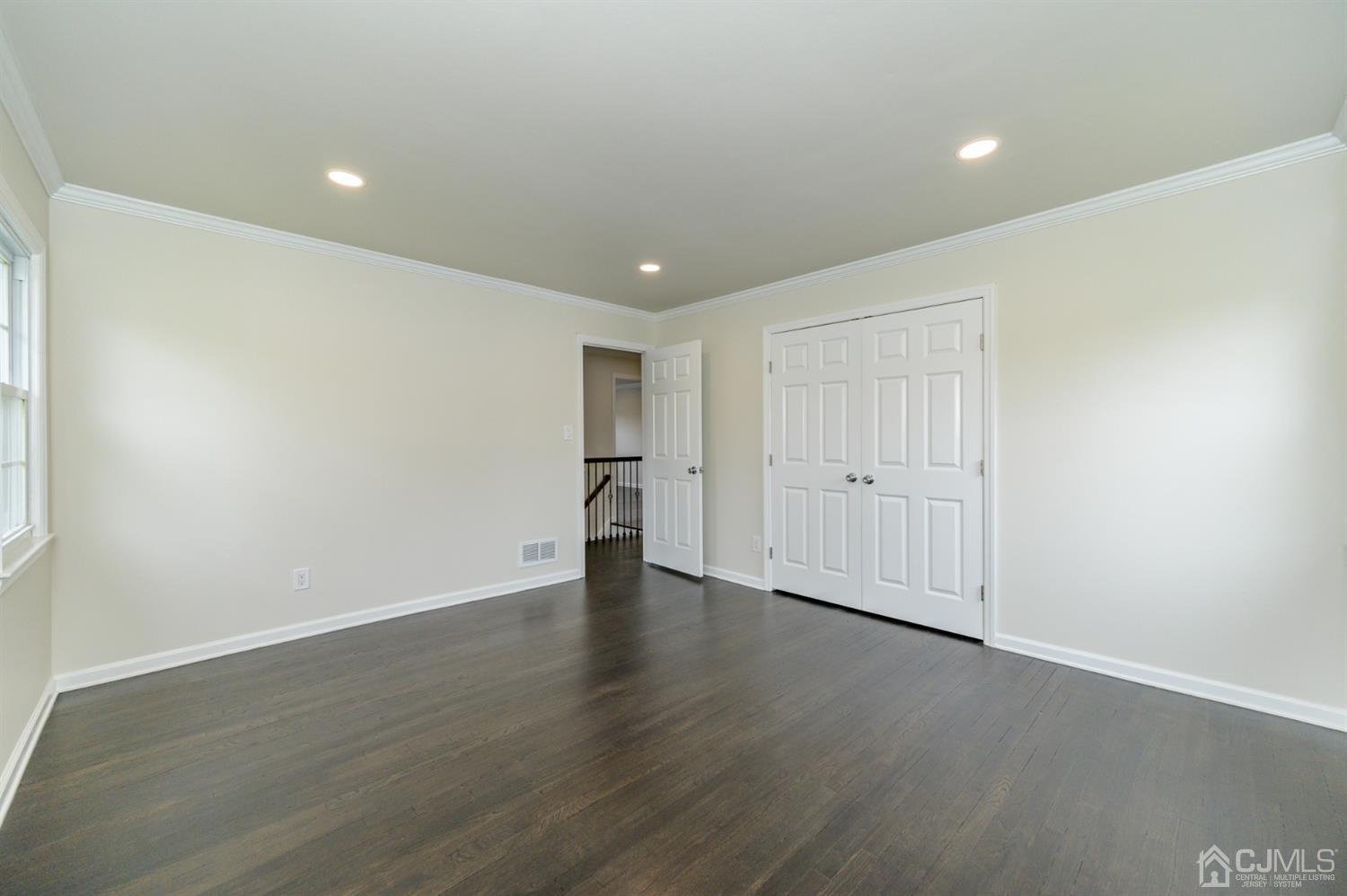 14 Shetland Road Florham Park, NJ 07932 - Photo 26 of 40 a view of an empty room with wooden floor and closet