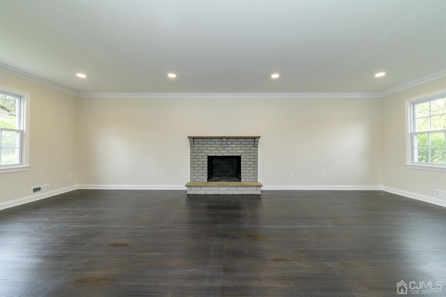 14 Shetland Road Florham Park, NJ 07932 - Photo 7 of 40 an empty room with wooden floor and fireplace