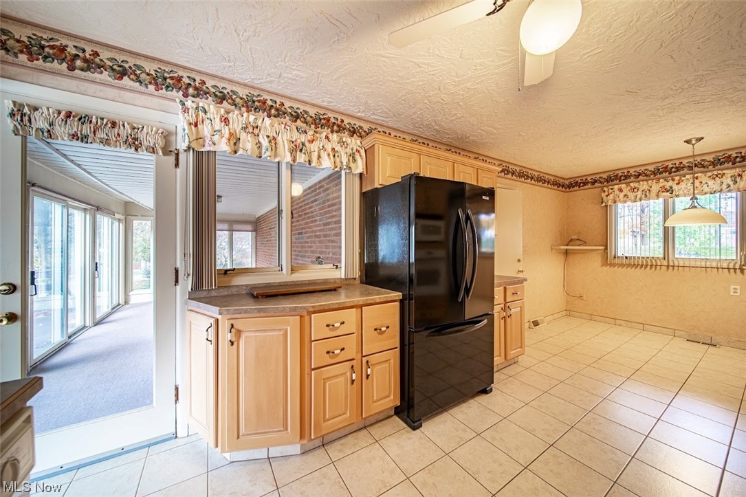 2323 Rockefeller Road Wickliffe, OH 44092 - Photo 4 of 34 Kitchen with plenty of natural light, ceiling fan, black fridge, and decorative light fixtures