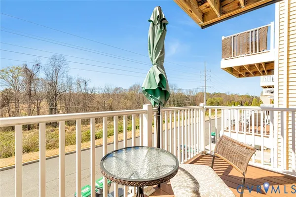 a view of a balcony with a table and chairs