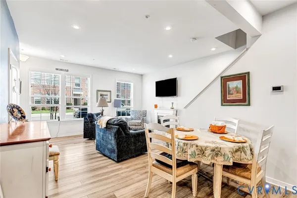 a living room with furniture a flat screen tv and a floor to ceiling window