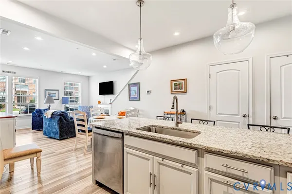 a kitchen with sink refrigerator and microwave