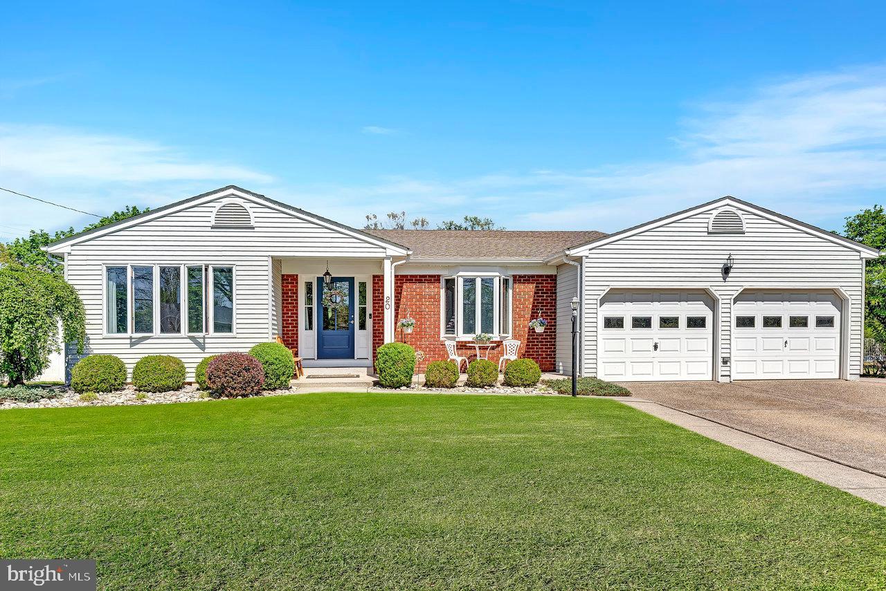 a front view of a house with a garden and porch