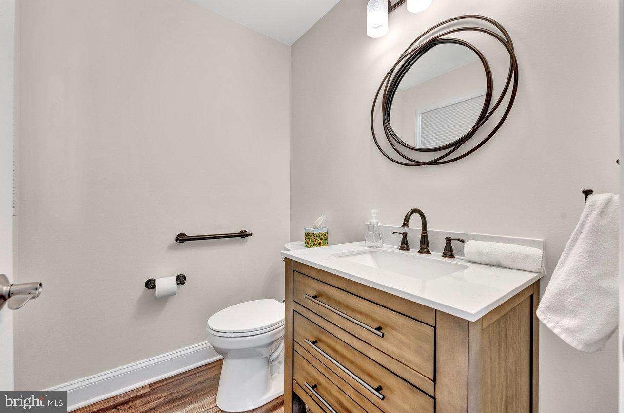 20 Wolfpack Road Hamilton, NJ 08619 - Photo 11 of 25 a bathroom with a granite countertop toilet a sink and a mirror