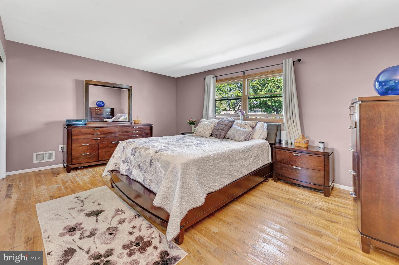 20 Wolfpack Road Hamilton, NJ 08619 - Photo 12 of 25 a bedroom with a large bed and a dresser next to a window