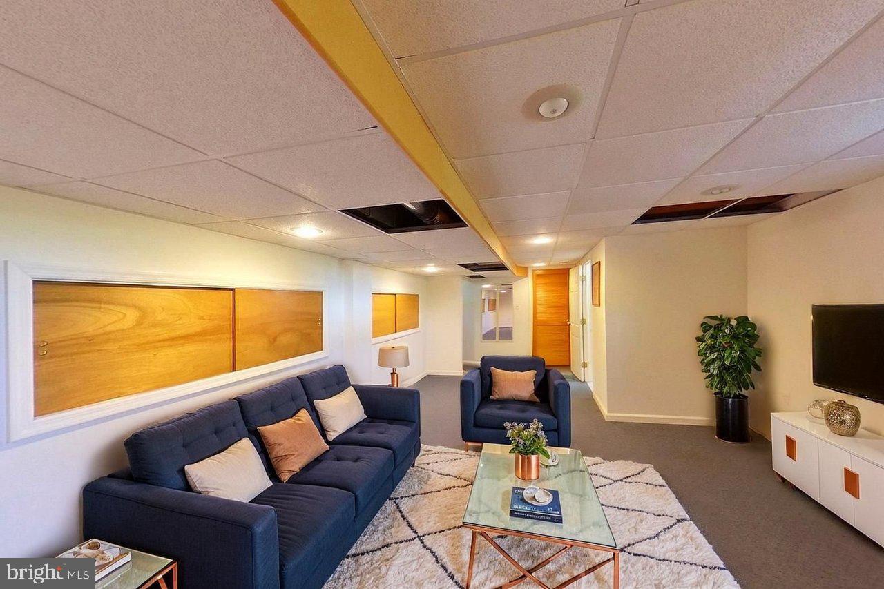 20 Wolfpack Road Hamilton, NJ 08619 - Photo 19 of 25 a living room with furniture a flat screen tv and a large window