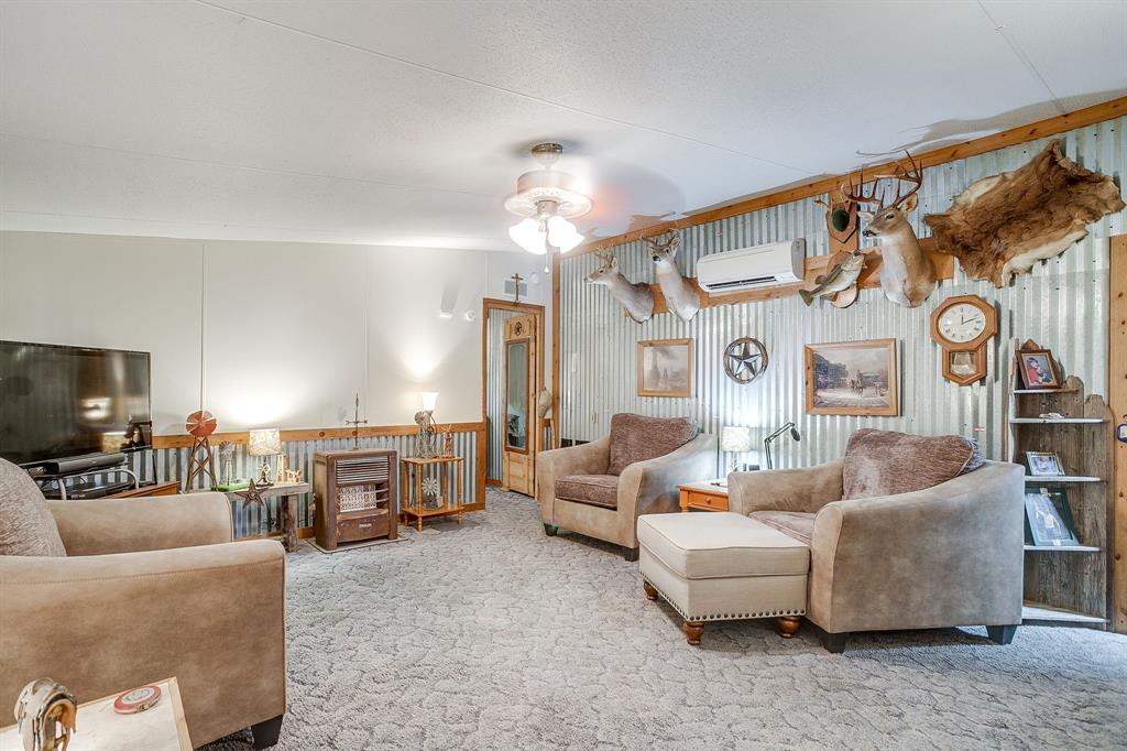 436 Luke Road Springtown, TX 76082 - Photo 13 of 39 Living room featuring carpet and a wall mounted AC