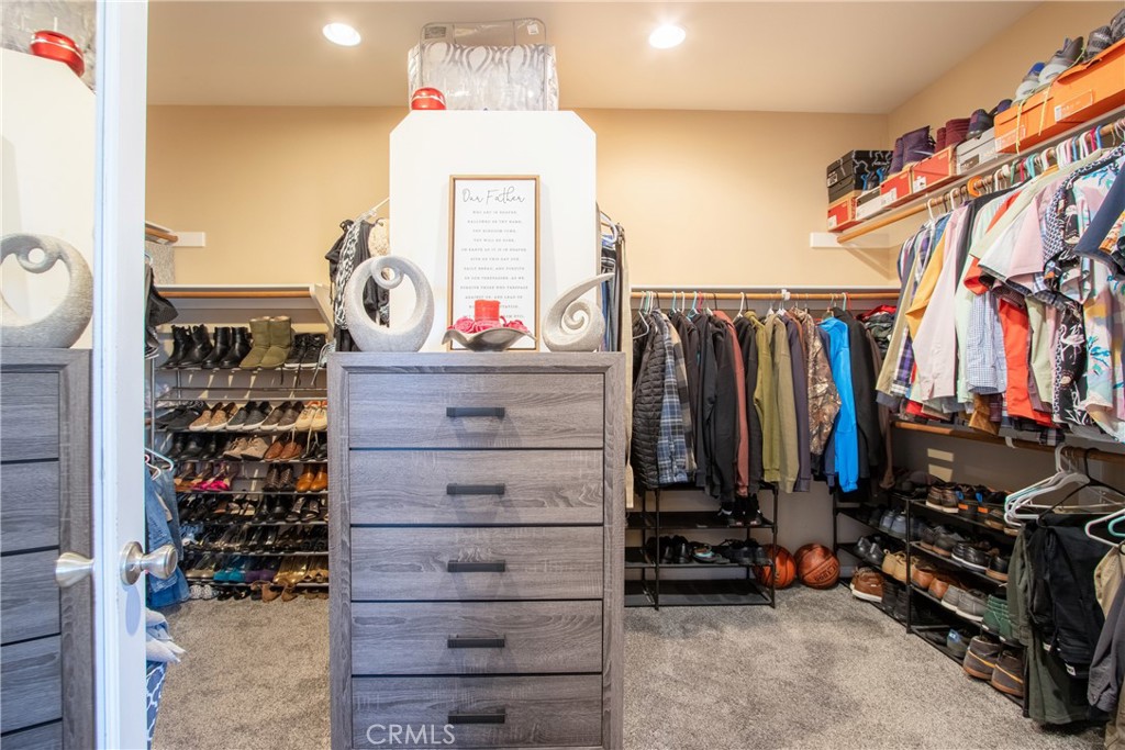 28483 Nautical Point Circle Menifee, CA 92585 - Photo 22 of 44 a view of walk in closet with clothes and shoes