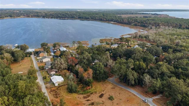 an aerial view of a house with a yard