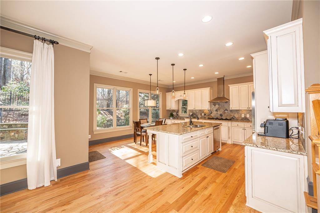 1103 Ridenour Court Northwest Kennesaw, GA 30152 - Photo 12 of 56 a large white kitchen with a large window and stainless steel appliances