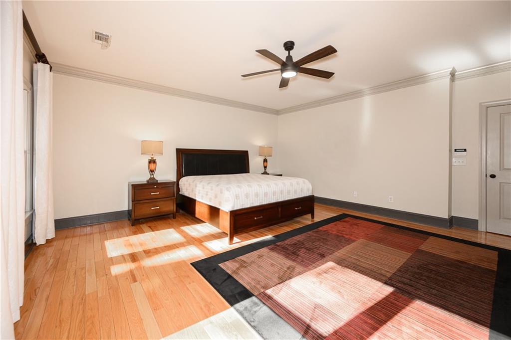 1103 Ridenour Court Northwest Kennesaw, GA 30152 - Photo 20 of 56 a bedroom with a bed and a chandelier
