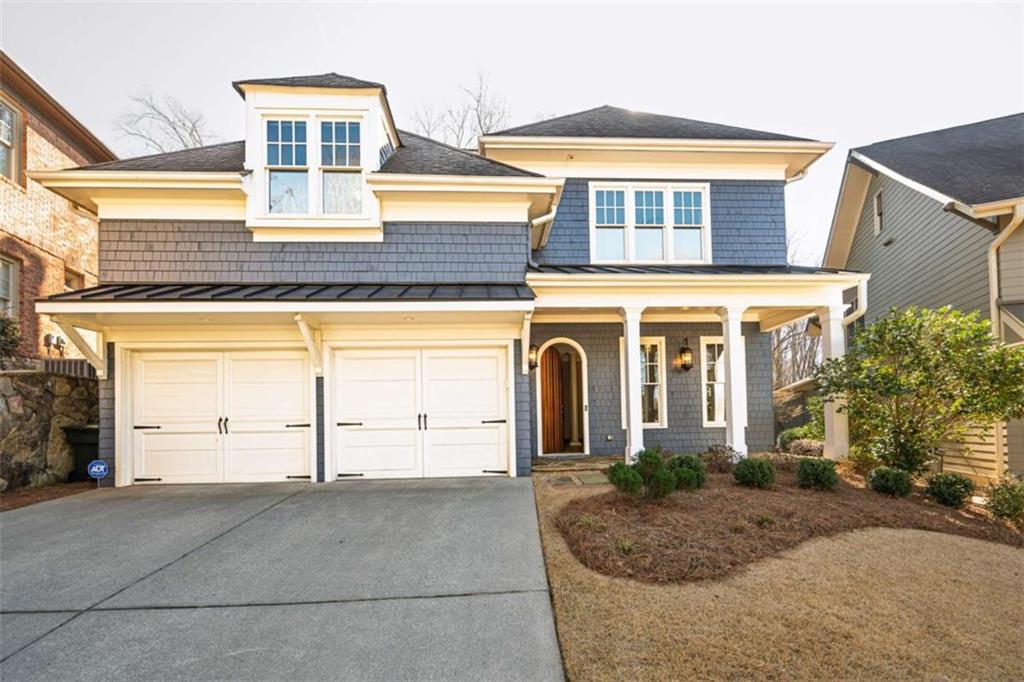 1103 Ridenour Court Northwest Kennesaw, GA 30152 - Photo 2 of 56 a front view of a house with a yard