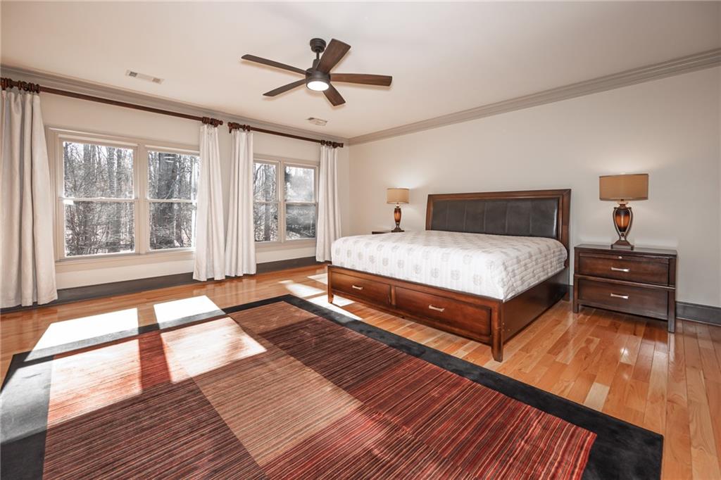 1103 Ridenour Court Northwest Kennesaw, GA 30152 - Photo 22 of 56 a bedroom with a large bed and a large window