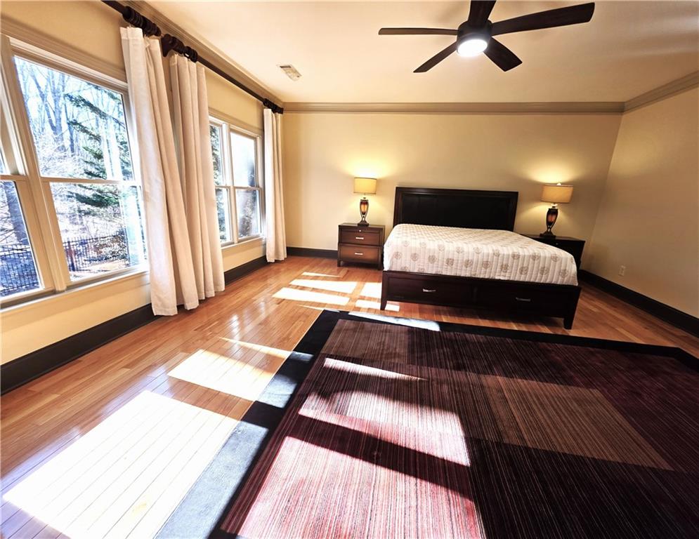 1103 Ridenour Court Northwest Kennesaw, GA 30152 - Photo 24 of 56 a bedroom with a bed and wooden floor