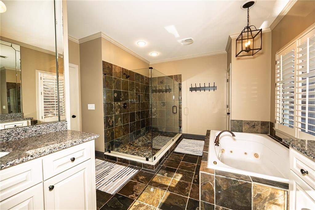1103 Ridenour Court Northwest Kennesaw, GA 30152 - Photo 30 of 56 a bathroom with a granite countertop sink a toilet and shower