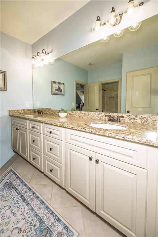 1103 Ridenour Court Northwest Kennesaw, GA 30152 - Photo 34 of 56 a bathroom with a granite countertop sink and a mirror
