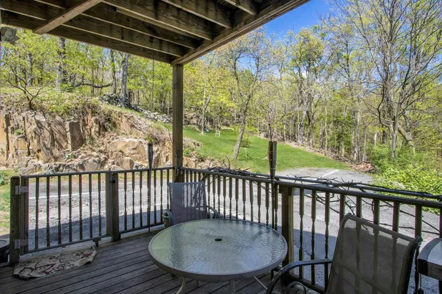 a view of a chair and table in the balcony