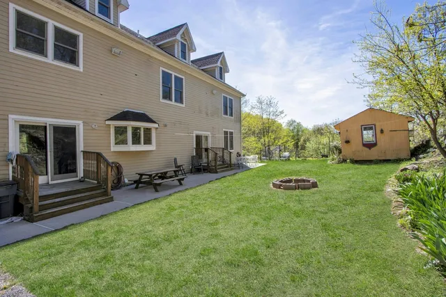 a view of a house with backyard sitting area and garden