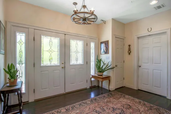 a view of a livingroom with a window and wooden floor