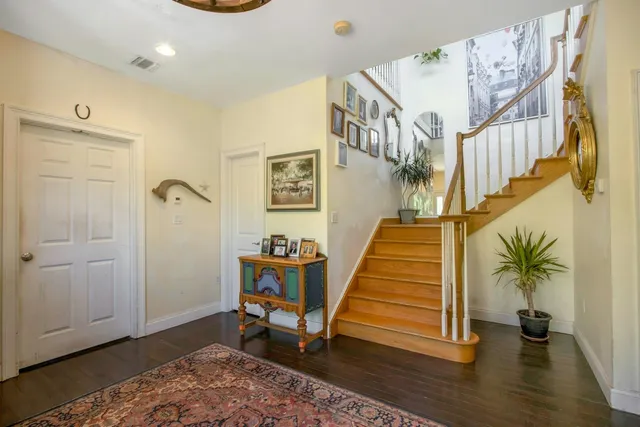 a view of entryway with wooden floor and stairs