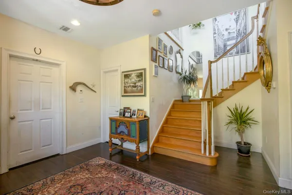 a view of entryway with wooden floor and stairs