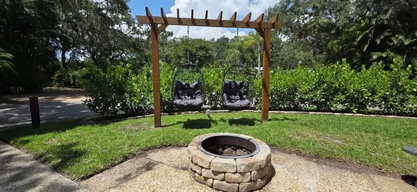 a view of a backyard with a garden and entertaining space