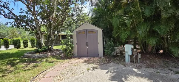 a wooden bench sitting in front of a house