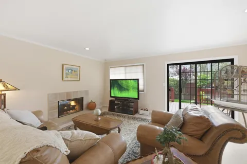 a living room with furniture large window and a flat screen tv