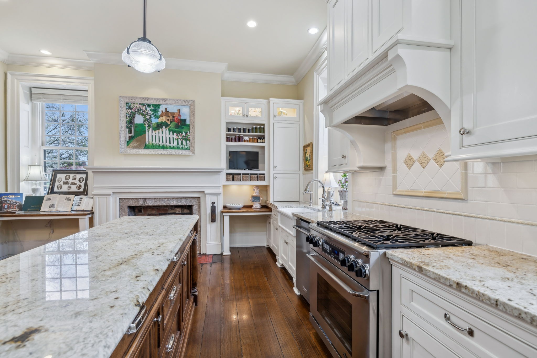 224 3rd Avenue South Franklin, TN 37064 - Photo 38 of 92 a kitchen with granite countertop a stove a sink a refrigerator wooden floor and cabinets