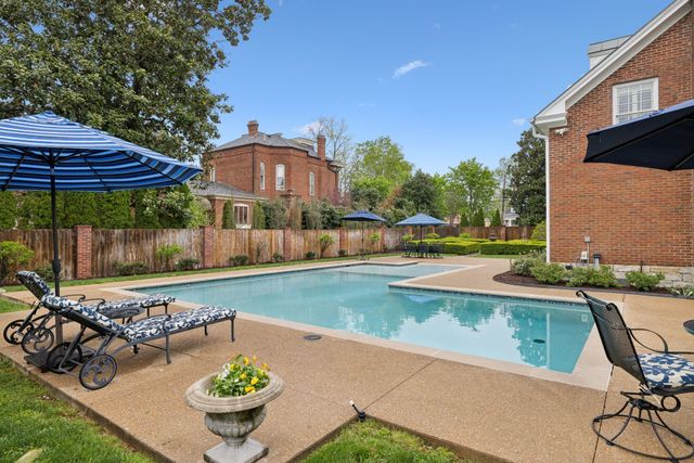 a view of a hallway with wooden floor and stairs