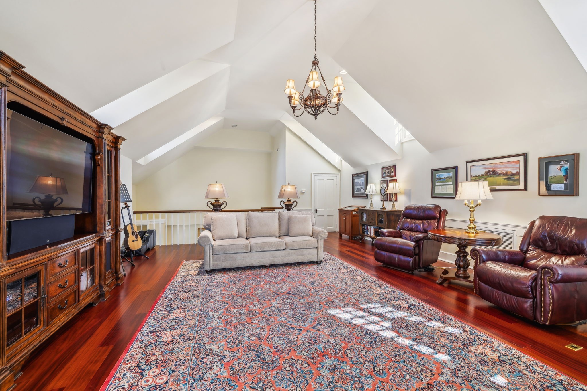 224 3rd Avenue South Franklin, TN 37064 - Photo 50 of 92 a living room with furniture a flat screen tv and a chandelier