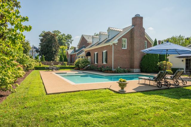 a view of a livingroom with furniture wooden floor and a chandelier