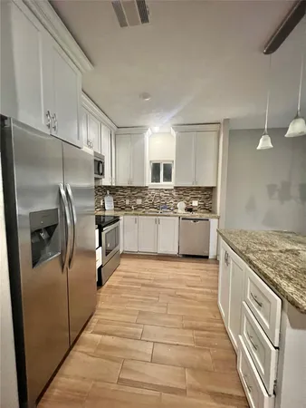 a bedroom with a bed and cabinets