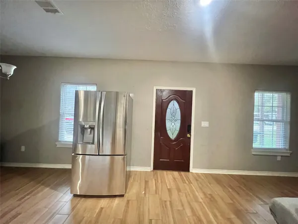 a view of bedroom with a bed and wooden floor